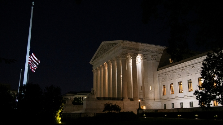 The flag outside the U.S. Supreme Court building flies at half-staff in honor of Justice Ruth Bader Ginsburg.