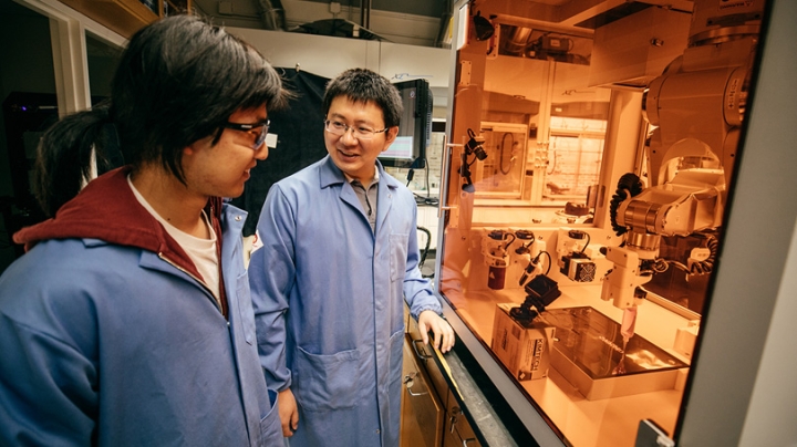 Assistant Professor of Chemistry Chenfeng Ke, right, talks with chemistry graduate student Miao Tang about a 3D printing project Tang designed. Ke is a co-chair of the interdisciplinary 3D printing conference hosted by Dartmouth next week. 