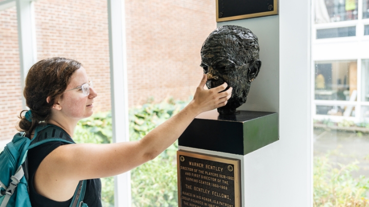 Elise Wien '17 takes part in an old tradition at Dartmouth: rubbing the nose of the Bentley bust when walking past it. 