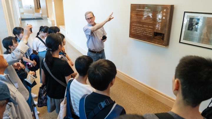 In the John Sloan Dickey Center for International Understanding, James Dorsey, an associate professor of Asian societies, cultures, and languages, shows visitors from Nihonmatsu, Japan, a commemorative plaque honoring Nihonmatsu native Kan’ichi Asakawa, C