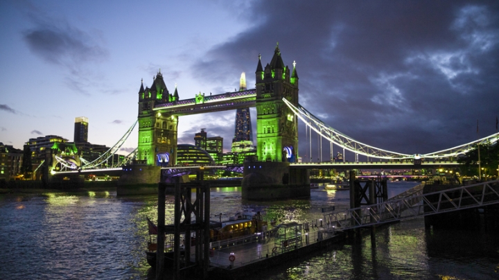 A picture of the Tower Bridge in London at night bathed in green light