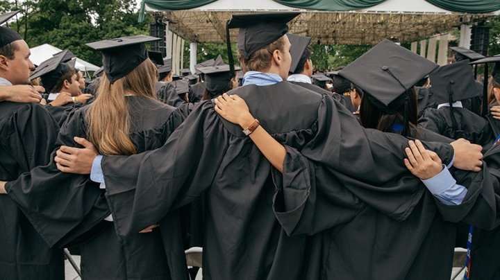 Students hug durring commencement 