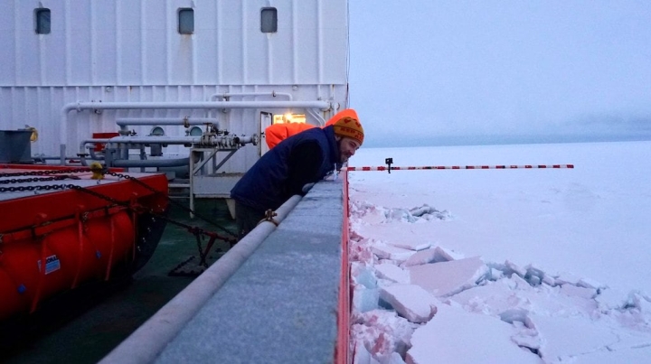 Aboard the Polarstern, Dartmouth engineering graduate student Ian Raphael '18, Thayer '21, watches an ice-thickness test.