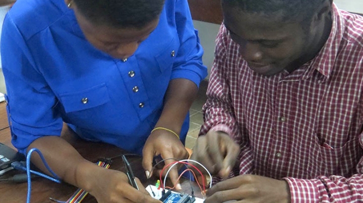 two students building a circuit board
