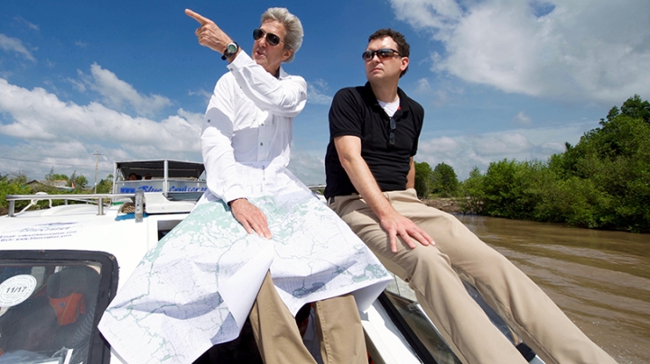 former Secretary of State John Kerry and Dartmouth history professor Edward Miller traveling the Mekong River Delta on a boat