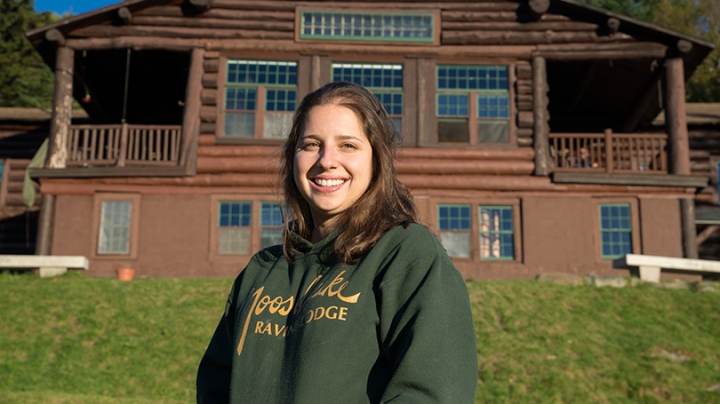 Maddie Lesser standing in front of Moosilauke Lodge