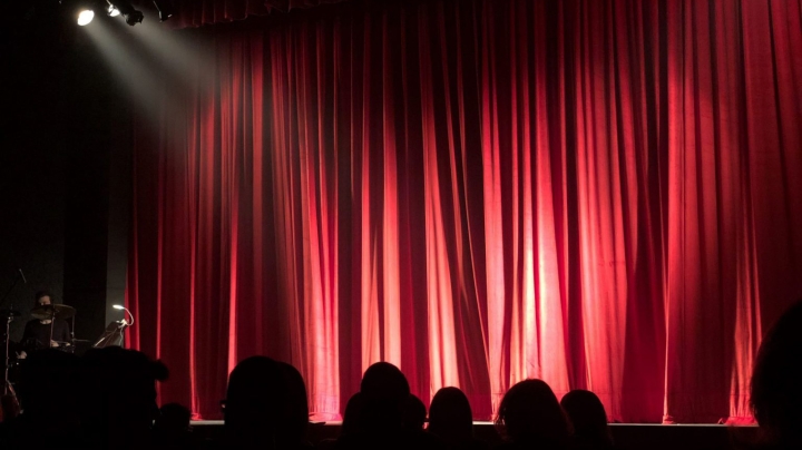 Red and black image of an audience in silhouette
