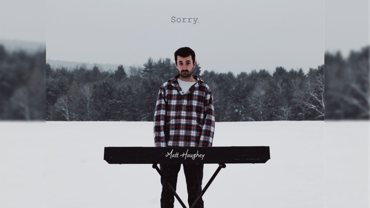 Matt Haughey '21 standing in a field of snow with his electronic piano