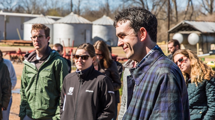 Tom Allin standing outside with a group of students