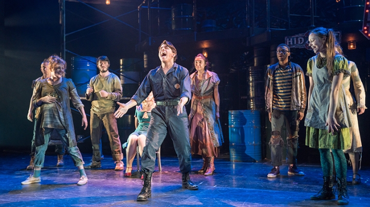 the cast of Urinetown performing on stage