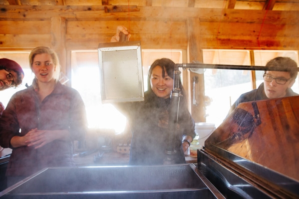 Students boil sap in the sugarhouse at the Dartmouth Organic Farm.