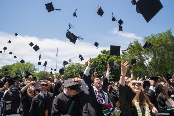Graduates tossing mortar boards in the air