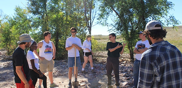 Professor Carl Renshaw, third from right, and graduate student John Gartner, second from right, instruct students in the field.
