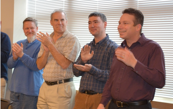 Nathan Paddock, far right, learns that he won the United Way grand prize.