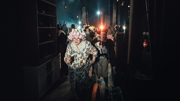 students in costume backstage during a dress rehearsal of Into the Woods