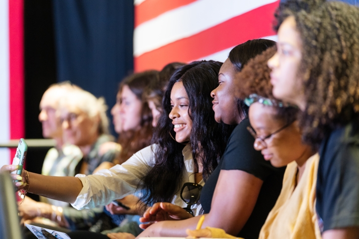 Kara Chamberlaine '21 takes a selfie with her friend Esther Omene '21, left, on stage in Alumni Hall on April 23, 2019, before a presidential campaign event with Sen. Kamala Harris.