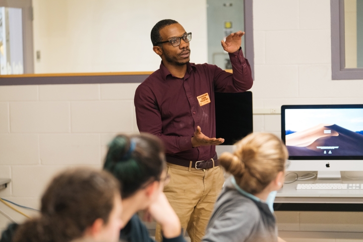 James Whitfield, an assistant professor of physics and astronomy, explains quantum computing to seniors at Hanover High School.