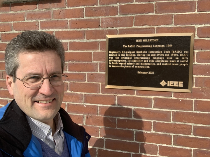 David Kotz '86, the Pat and John Rosenwald Professor of Computer Science, stands next to the IEEE Milestone plaque outside the south entrance to the Collis Center after it was installed earlier this month.