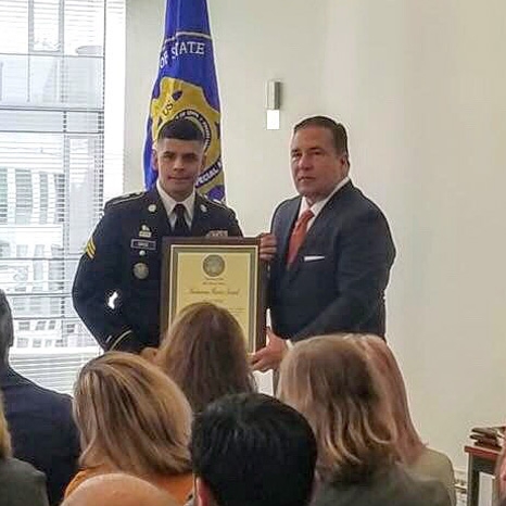 U.S. Department of State Assistant Secretary for Diplomatic Security Michael Evanoff presents a Meritorious Honor Award to Jhon Ortiz '20.