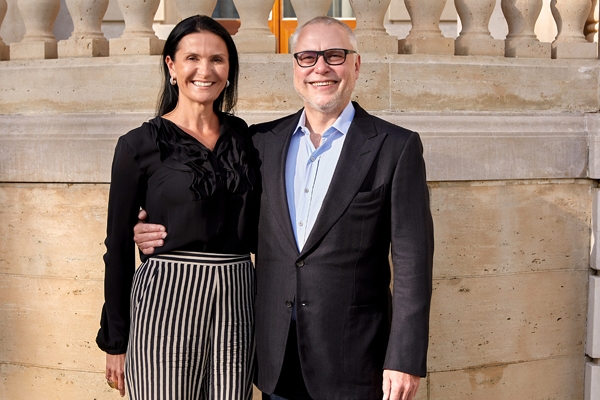 A photo portrait of Michaela and Zdenek Bakala, Tuck '89. Zdenek has his right arm around Michaela.