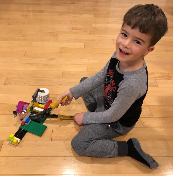 Ezra Gilbert-Diamond, age 5, demonstrates the Logo wire-cutting jig he helped his father, Associate Professor Solomon Diamond, design for the Dartmouth High Performance Mask project.