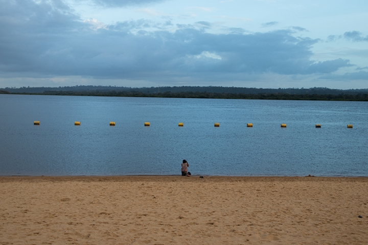 A woman looks out on the Xingu River.