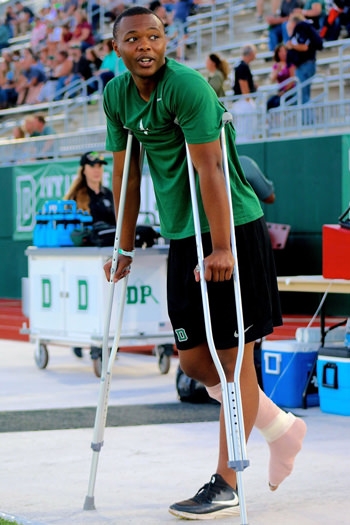 Darryl Mobley stands on crutches