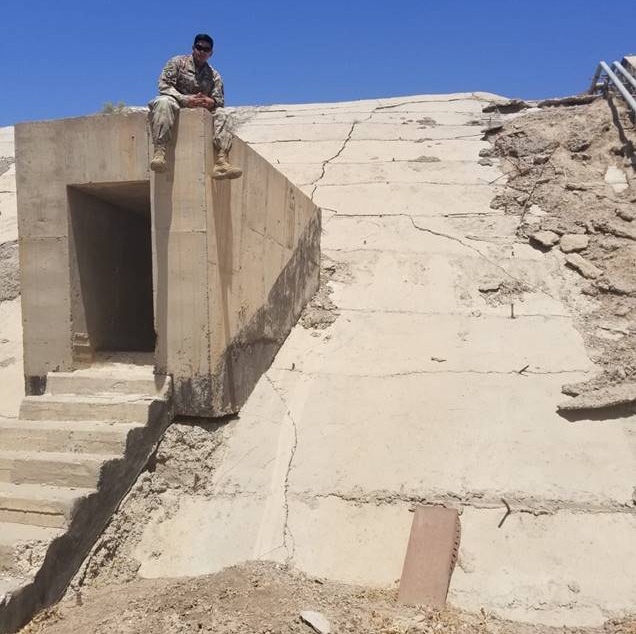 Jhon Ortiz '20 perches on top of one of Saddam Hussein's bunkers near the Baghdad airport during his deployment in Iraq. (Photo courtesy of Jhon Ortiz '20)