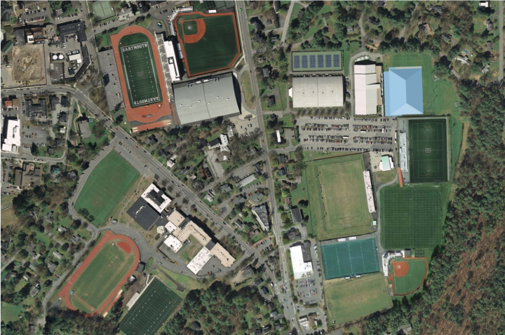 An overhead view of athletic fields and buildings shows the future location of the practice facility