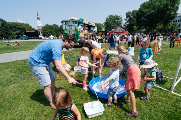 Several families make giant bubbles at one of the several children’s activity stations run by Hanover Parks and Recreation. (Photo by Eli Burakian ’00)