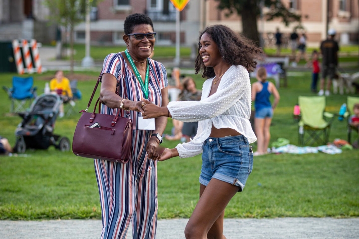 Members of the evening concert crowd dance on the Green. Sophomore students and their families, in town for Dartmouth Family Weekend, were welcome to join in the community celebration. (Photo by Lars Blackmore)