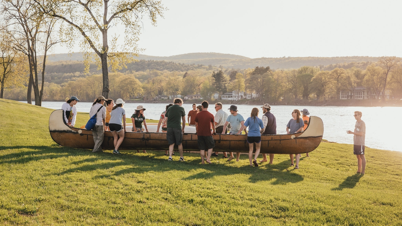 Seniors carrying a canoe to the Connecticut River.