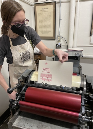 Tuck student Katie Shultz prints a letterpress valentine.
