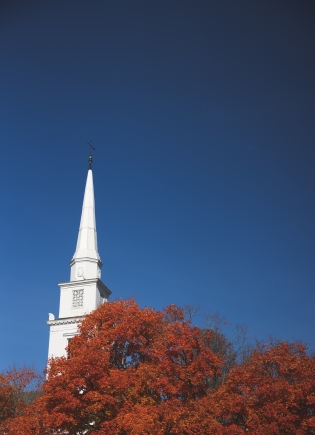 The Unitarian church steeple with red leaves