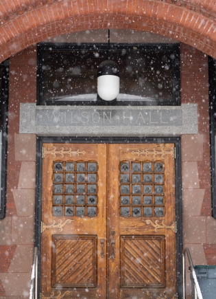 Wilson hall double doors during snowfall