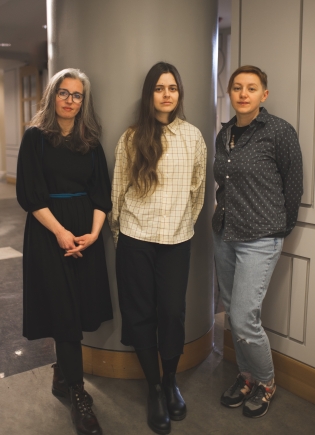 Exhibit curators Jill Baron, Veronika Yadukha, and Hanna Leliv pose for a photo in the library.