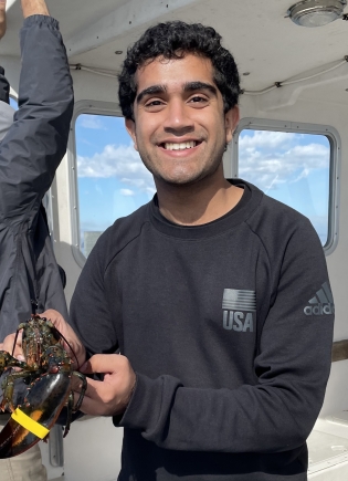 Pulkit Nagpal '23 in a lobster boat.
