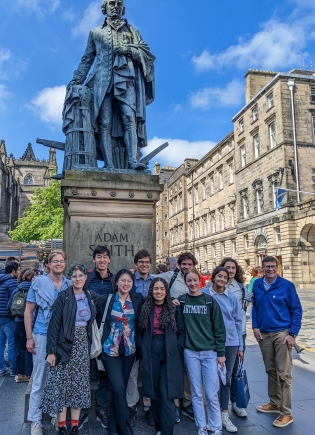 Students and faculty at monument to Adam Smith