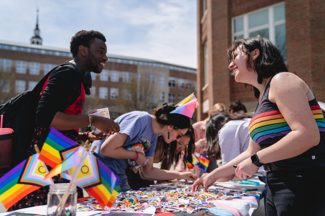 Students looks for Pride stickers at the event.